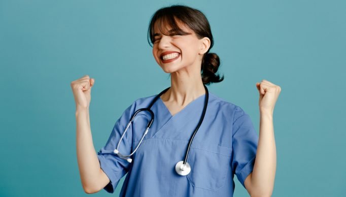 excited_young_female_doctor_wearing_uniform_fith_stethoscope_isolated_blue_background-24091003