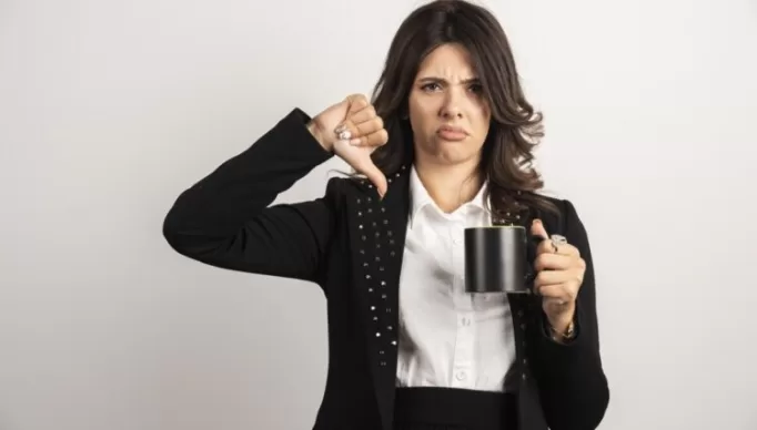 Female office worker giving thumbs down. High quality photo